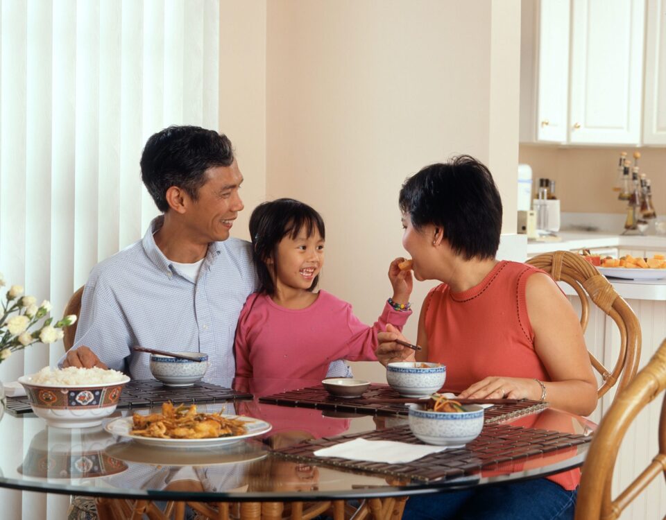 family sitting at the kitchen table sharing a meal